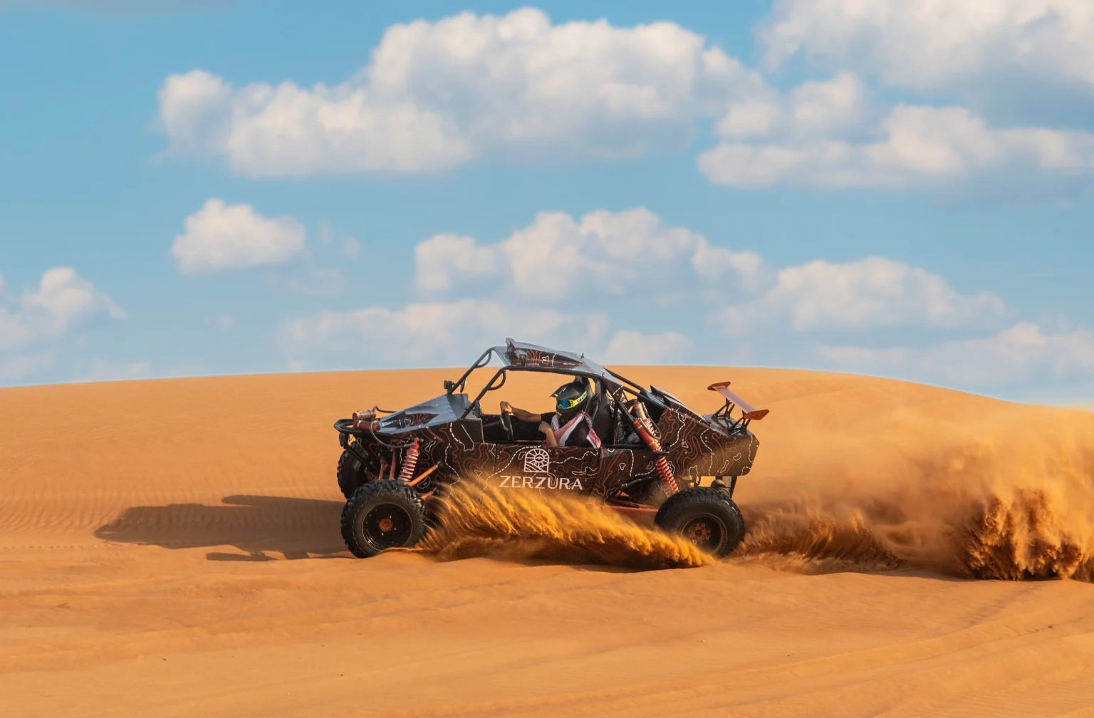 Explorer Tours guest driving a dune buggy during desert safari Dubai